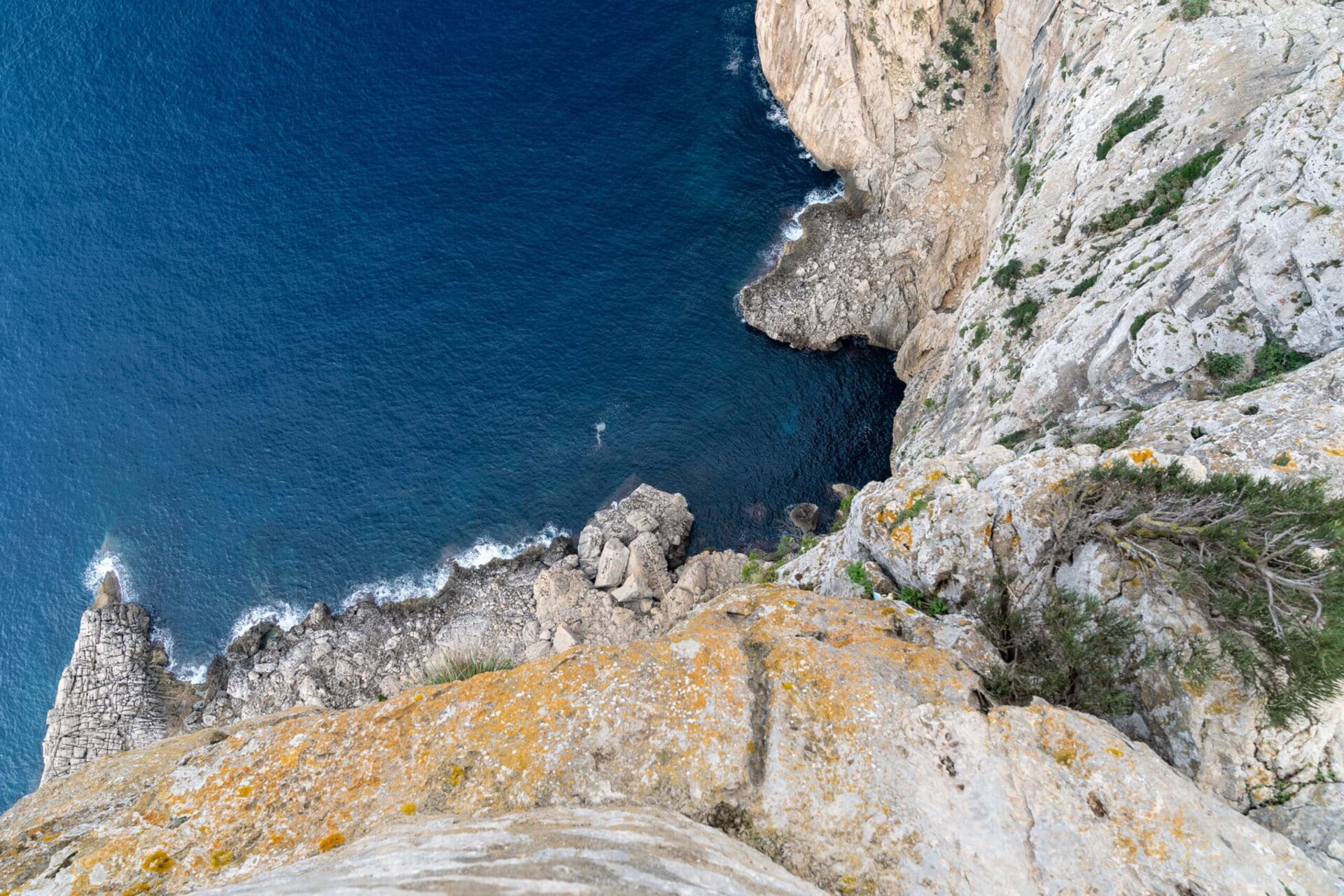 Dramatic cliff overlooking deep blue ocean water